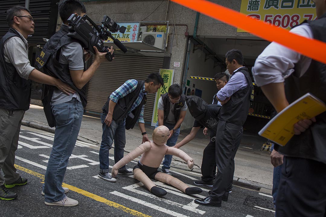 2015年10月19日,一名內地遊客懷疑因為購物問題被毆打至重傷,其後死亡。警方將其中一名疑犯──44歲的港人導遊胡彥南,押返紅磡案發現場重組案情。攝:羅國輝/端傳媒